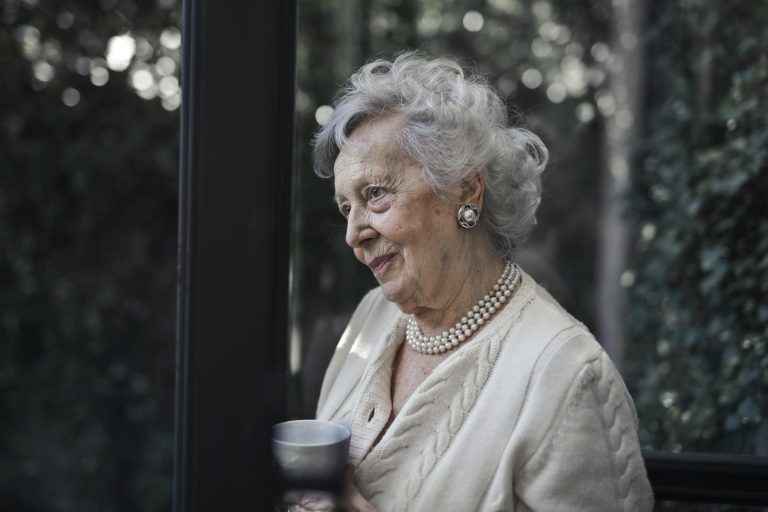 Woman Wearing White Top While Holding Ceramic Mug